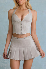 Low-Rise Pleated Mini Skirt in Ecru